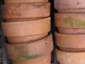 stack of clay pots, transplant houseplants