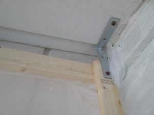 brace between ceiling and 1 x 2" post